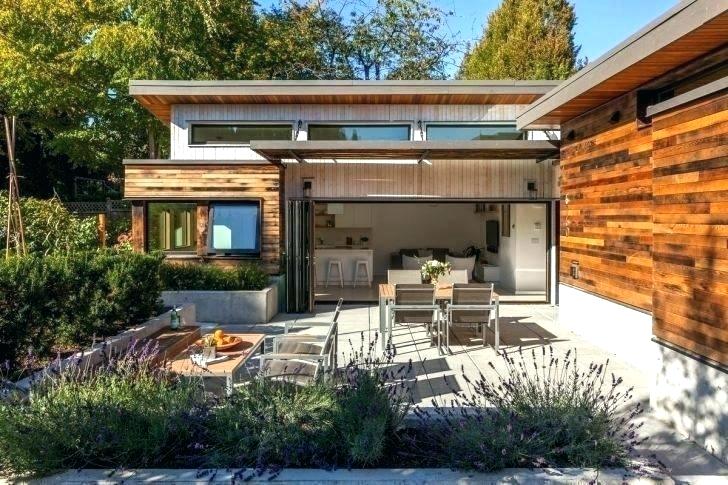 Slim frame bifold glass doors opening onto modern patio